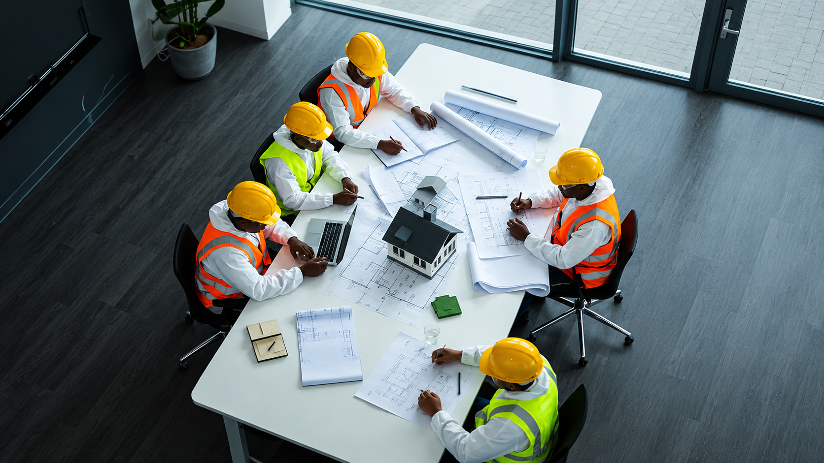 Construction professionals reviewing building plans together